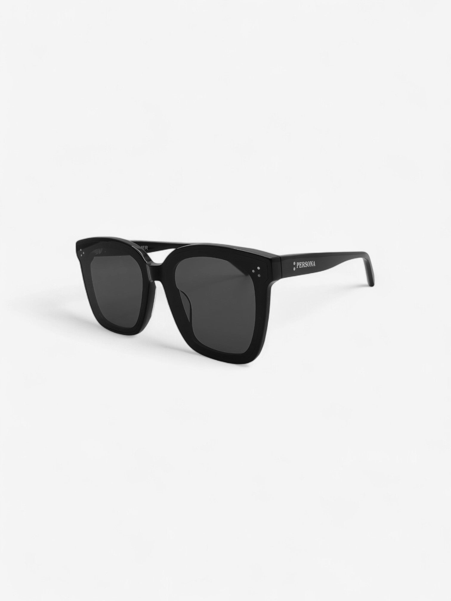 Angled view of Charmer black sunglasses - unisex oversized style