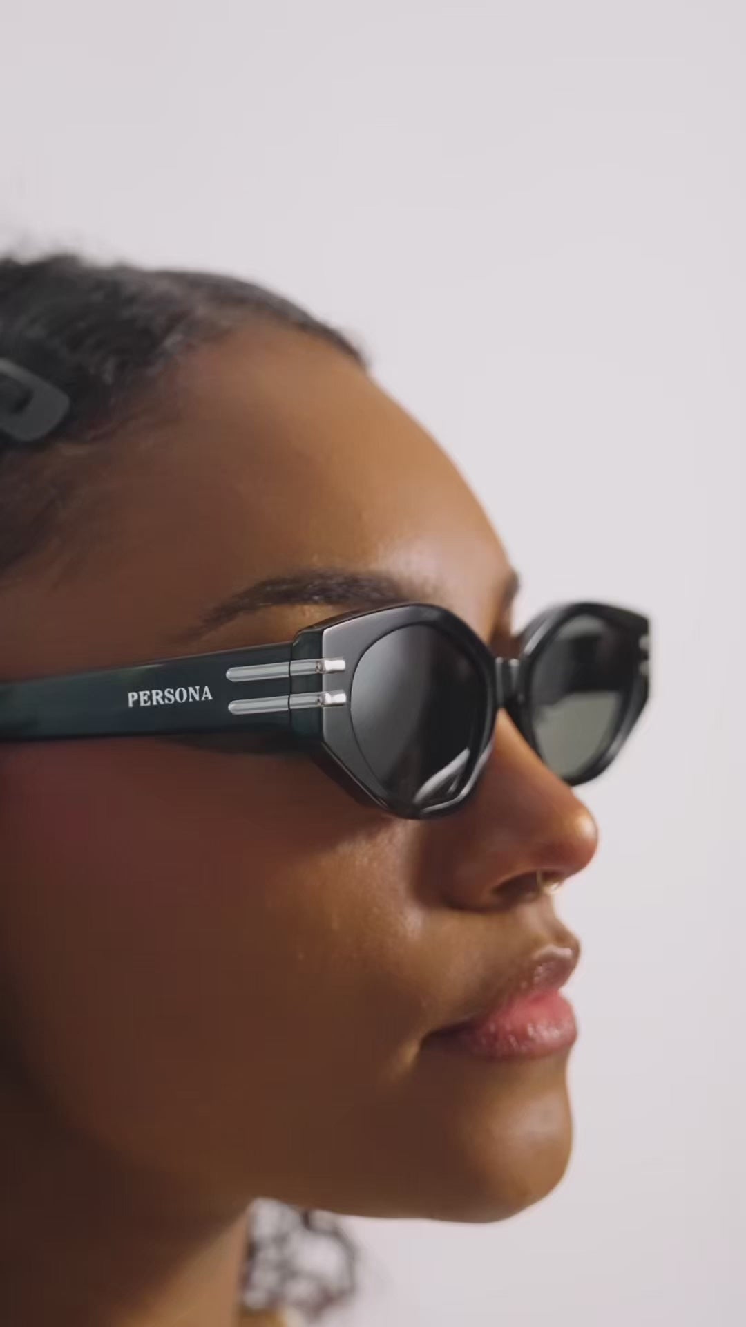 Side profile of stylish woman in Rebel sunglasses - black acetate frames 