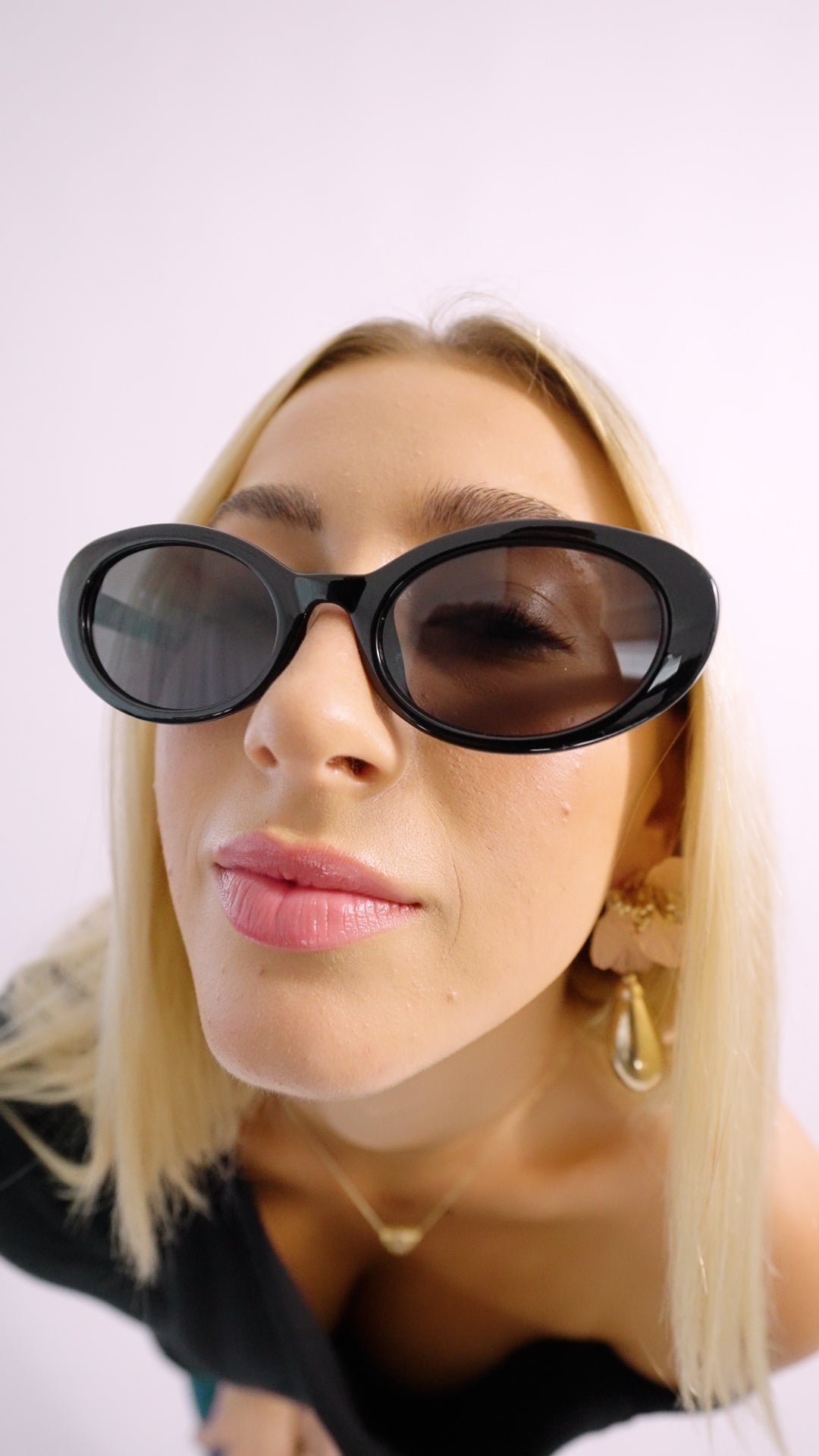 Stylish woman wearing black cat-eye sunglasses - The Social Butterfly - retro 100UV protection 