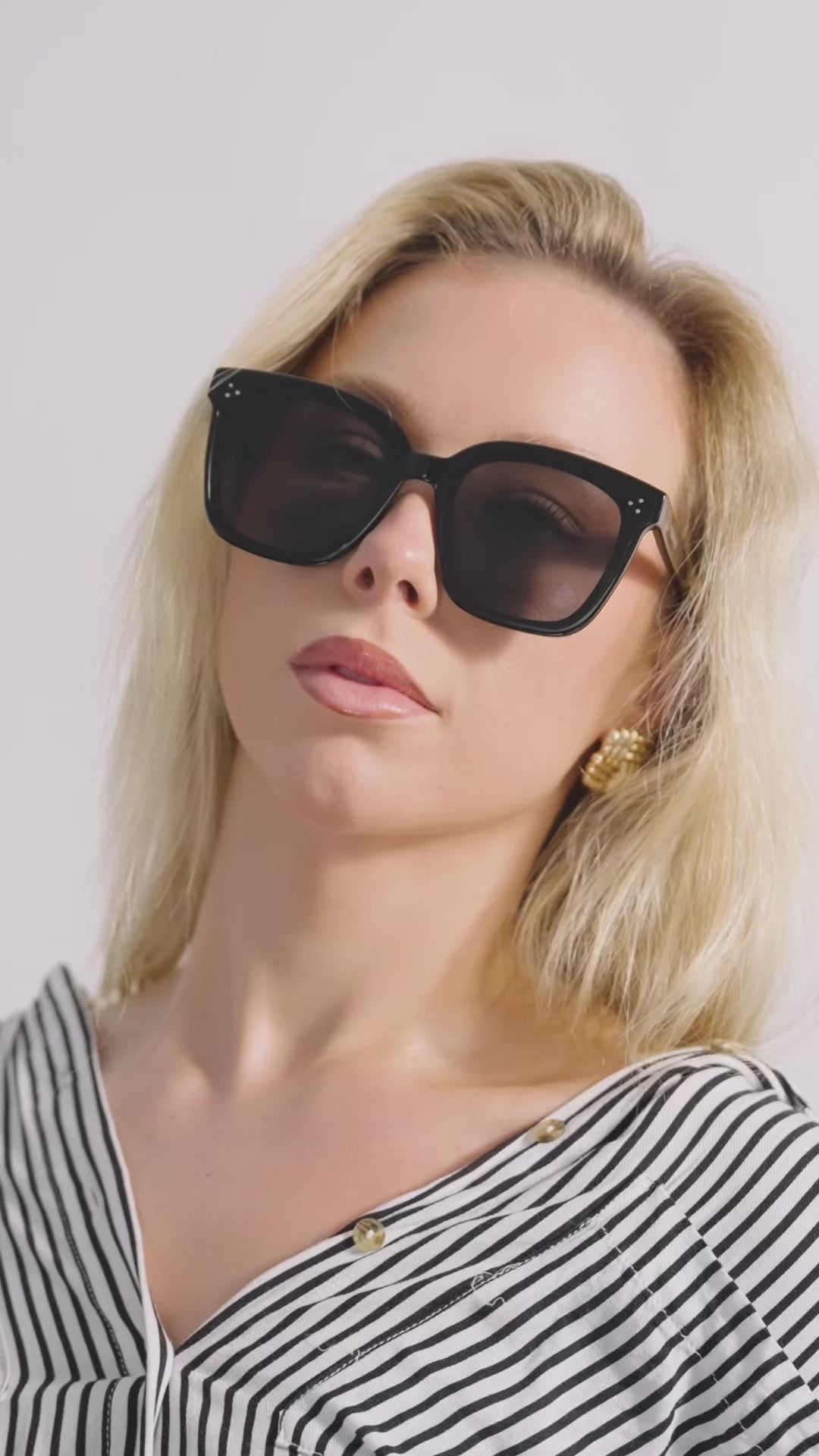 Sophisticated woman wearing The Charmer sunglasses - modern unisex style 