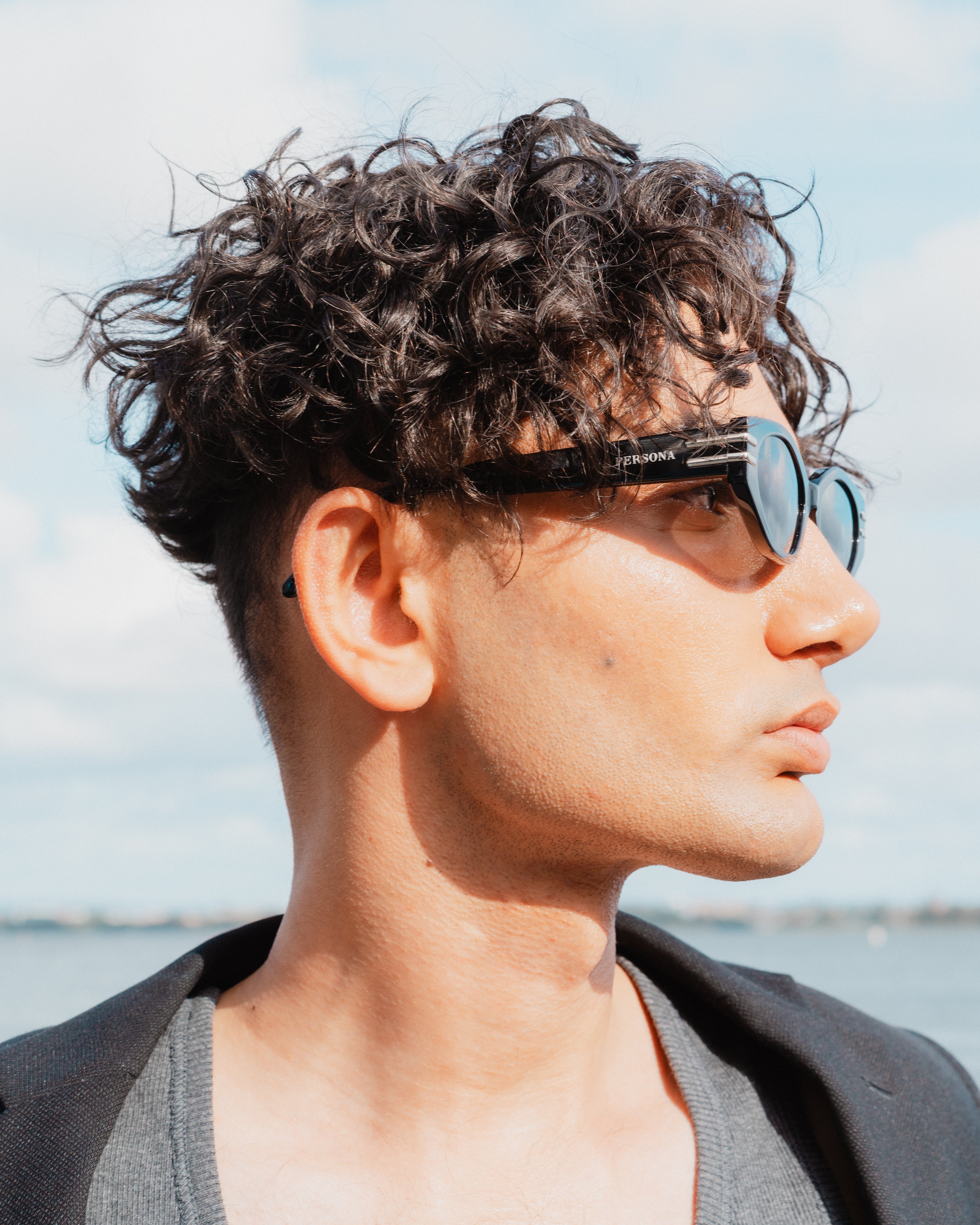 Side profile of stylish man in Rebel sunglasses - black acetate frames 