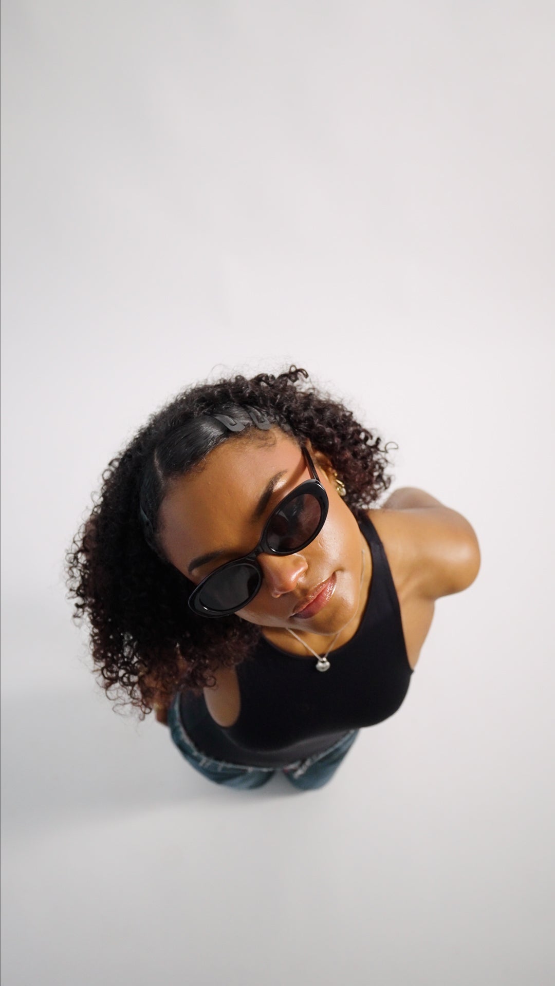 Confident woman wearing The Social Butterfly sunglasses - lightweight unisex design 